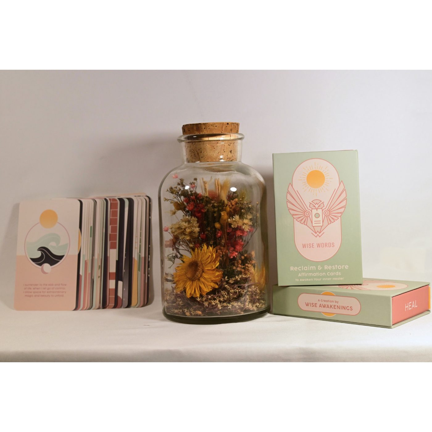 Wise Words Reclaim & Restore affirmation deck beside a jar of dried flowers